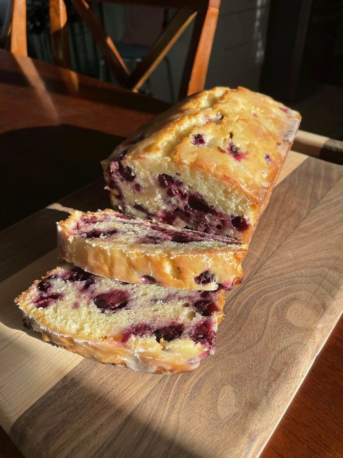 Sliced blueberry loaf cake on a wooden board showcasing one of the incredible bakes perfect for highlighting.