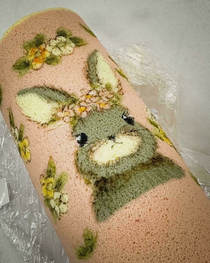 Roll cake featuring an intricate bunny and floral design, showcasing one of the incredible bakes that deserve the spotlight.
