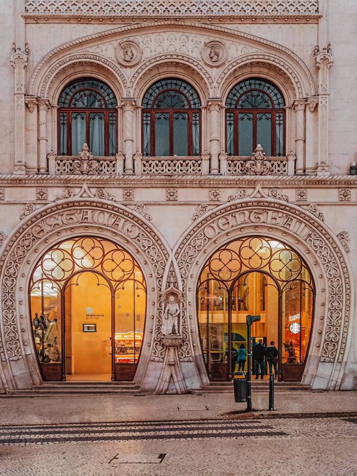 Ornate building façade featuring intricate arches and large windows showcasing impressive architectural feats.