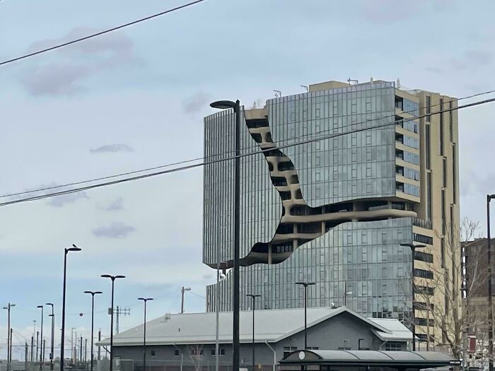 Modern building with a large, irregular crack-like design, resembling an evil building from horror movies.