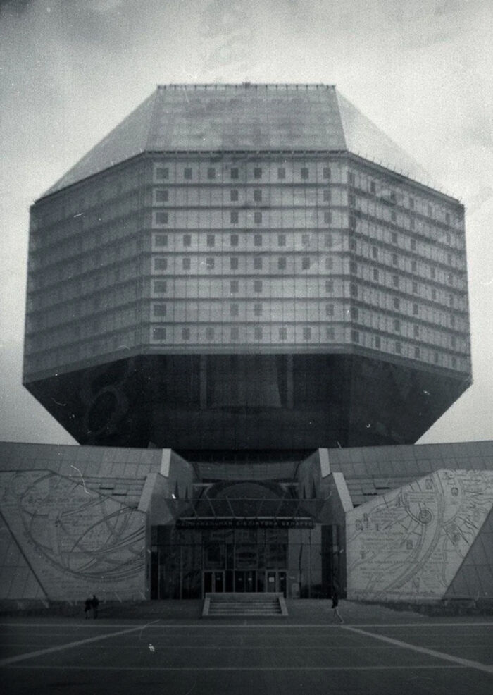 Massive dark brutalist building with a menacing design, resembling evil buildings from horror movies.