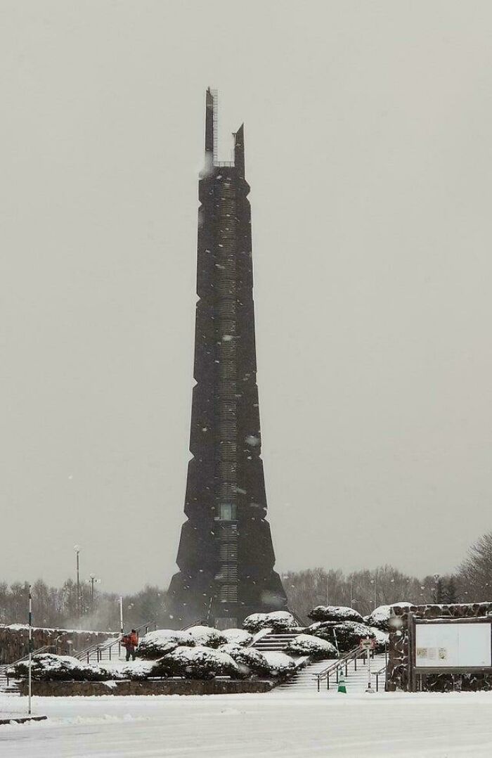 Tall evil building with a dark, ominous design standing in a snowy landscape, reminiscent of horror movie settings.