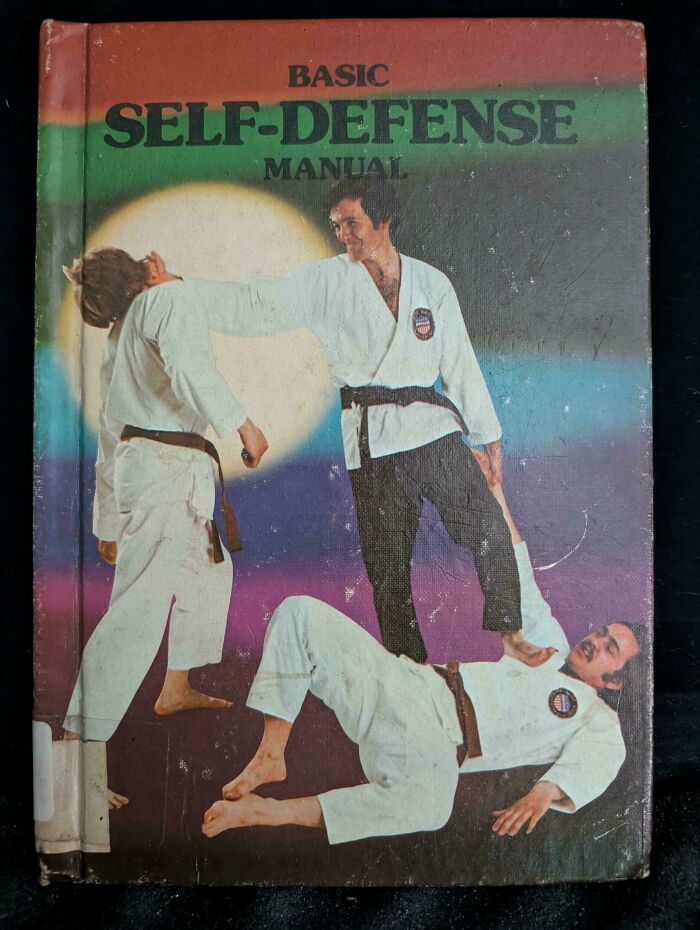Book cover of Basic Self-Defense Manual featuring men in karate uniforms in an awkward martial arts pose, a funny book cover example