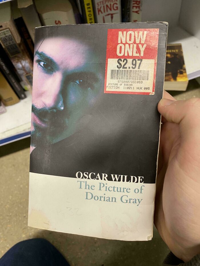 Book cover of The Picture of Dorian Gray with awkward close-up photo and a price sticker, showcasing funny book covers.