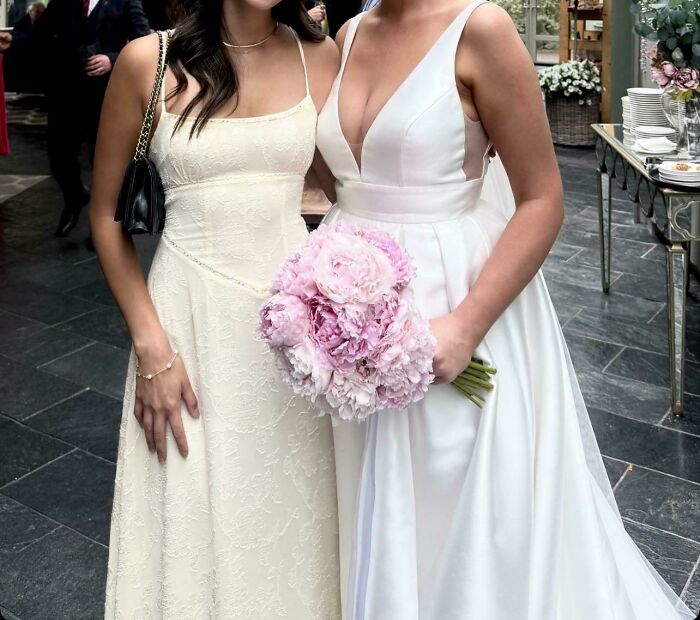 Two women at a wedding, one in a white bridal gown holding a bouquet, capturing the worst brides and wedding guests.