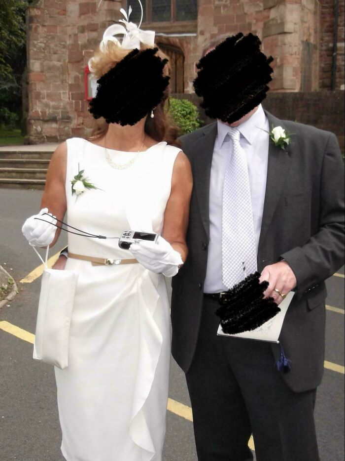 Bride and groom in wedding attire outside a church, showcasing some of the worst brides and grooms shamed online.