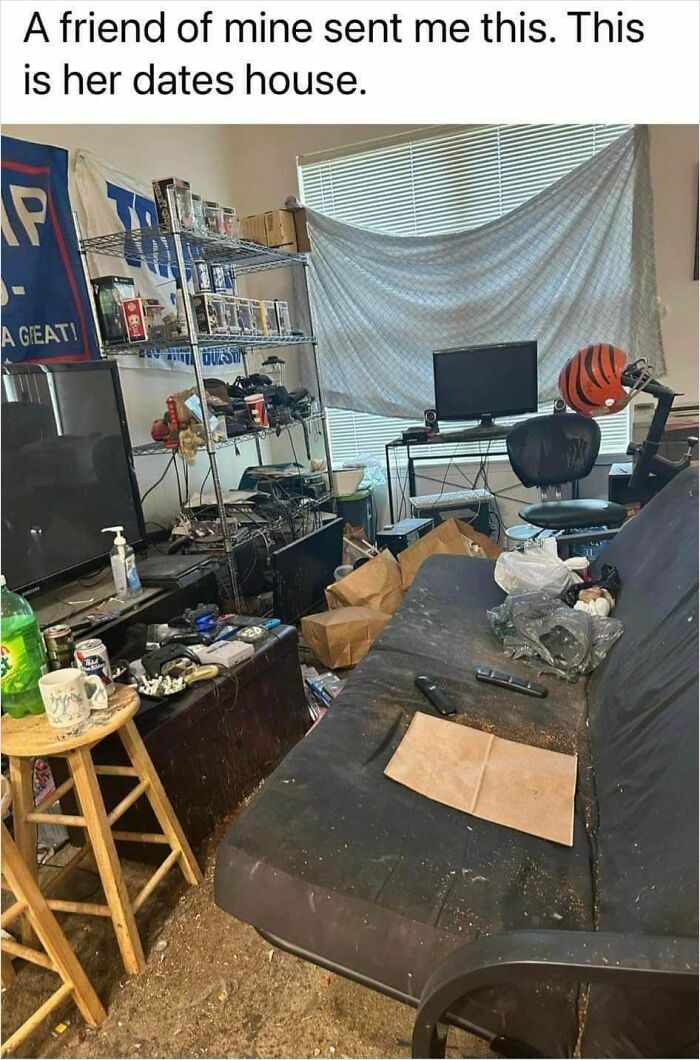 Cluttered, messy living room with dirty couch, computer setup, and trash scattered, illustrating challenges of finding love online.