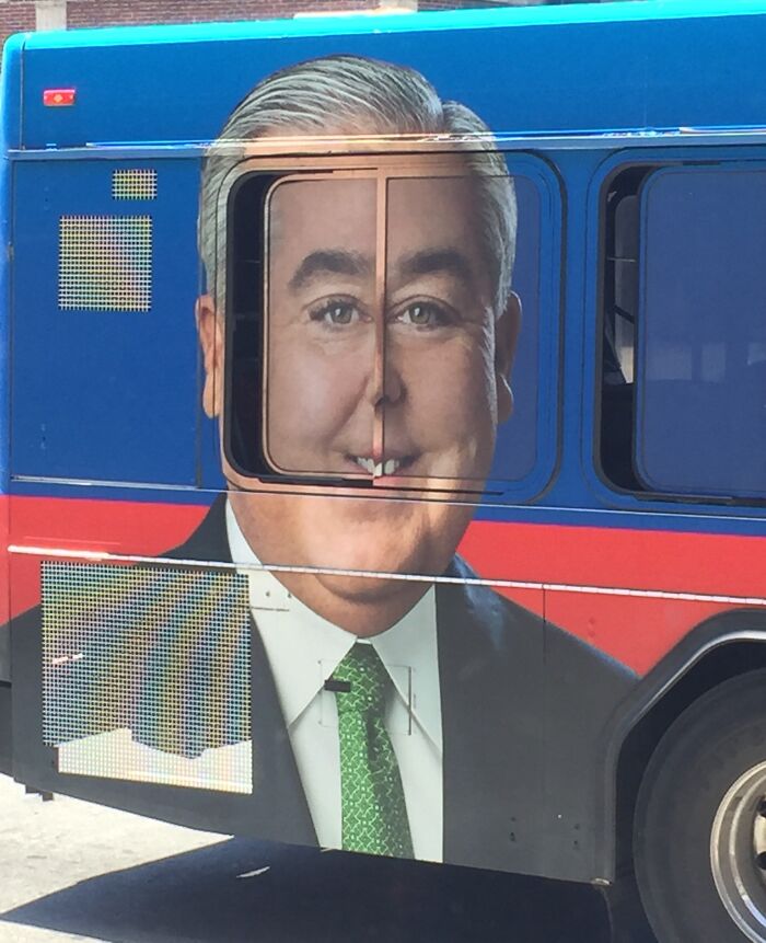 Bus advertisement with a man's face distorted by bus window placement, illustrating funny advertising fails.