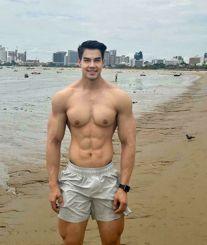 Muscular man posing shirtless on a beach, illustrating Instagram vs reality pics showing distorted body expectations.