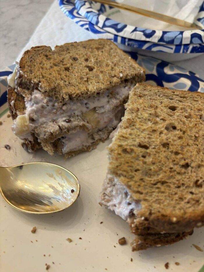 Sandwich with unusual filling of cream and banana on whole grain bread, representing stupid dishes and strange food combinations.