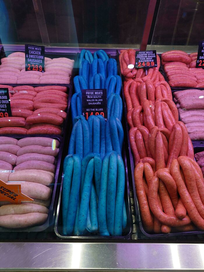 Unusual blue sausages displayed among regular meat sausages illustrating dishes that are just stupid.