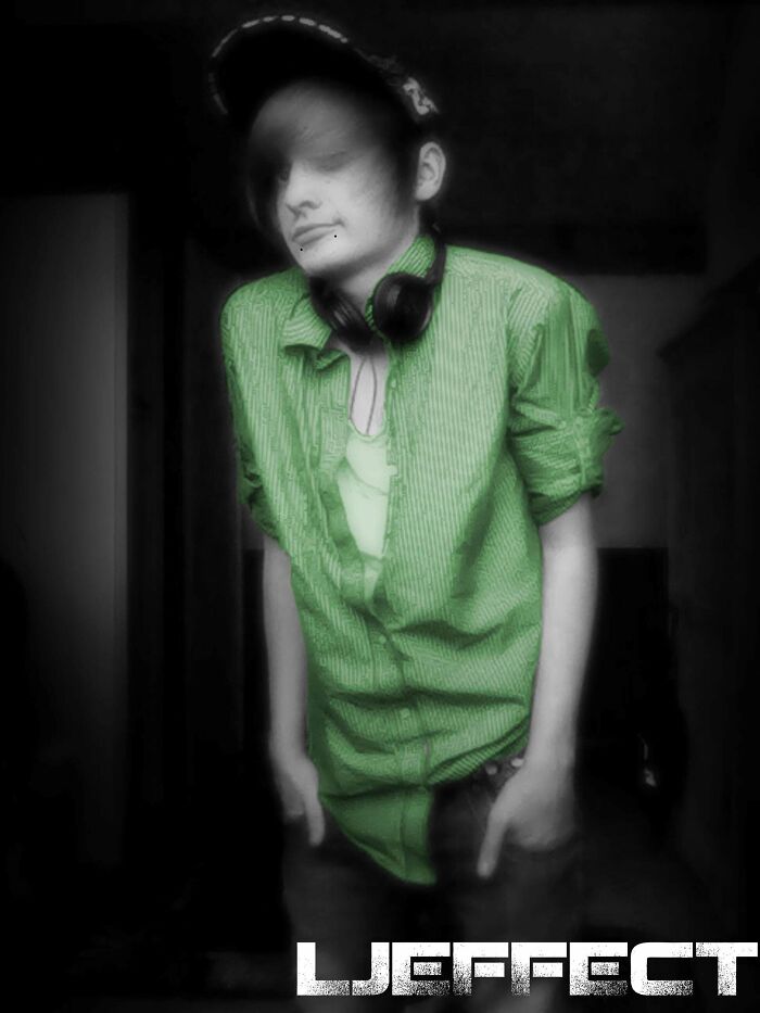 Teen wearing a green shirt and cap with headphones around neck, capturing a regrettable past cringe moment.