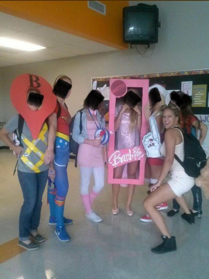 Group of people in creative costumes posing indoors, showcasing funny and cringe-worthy moments from regrettable past photos.