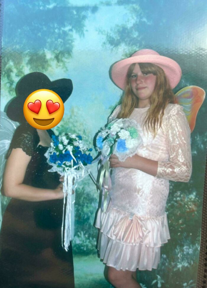 Two girls in vintage dresses and hats holding flower bouquets, a relatable pic from people’s regrettable past.
