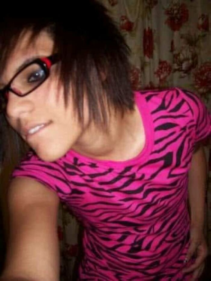 Teen wearing pink zebra-print shirt and large glasses, posing for a regrettable past cringe photo.