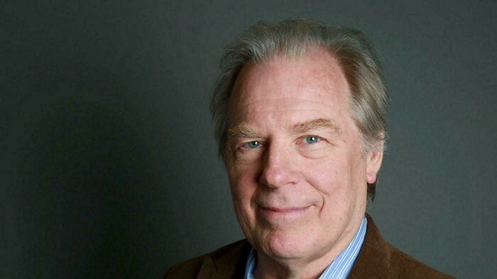 Portrait of an older man smiling subtly, representing people who recognize things that make them feel very old.