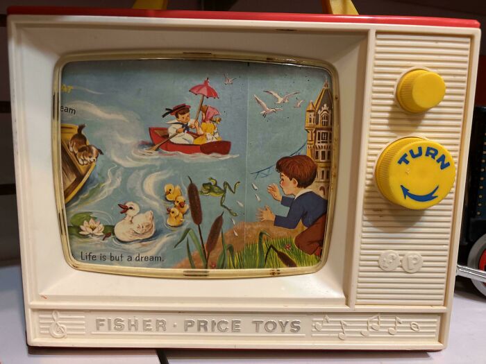 Vintage Fisher Price toy TV with colorful storybook scene, a nostalgic item that makes people who recognize it feel very old.