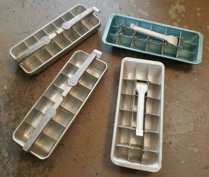 Vintage metal ice cube trays with levers, classic items that make people who recognize them feel very old.