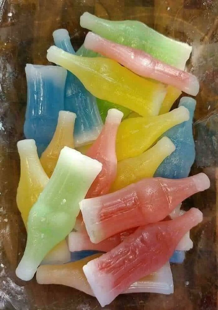 Colorful vintage soda bottle candies in a bowl, a nostalgic treat that makes people who recognize them feel very old.