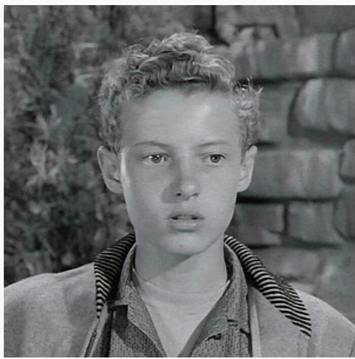 Black and white close-up of a young boy with curly hair, representing things that make people feel very old.