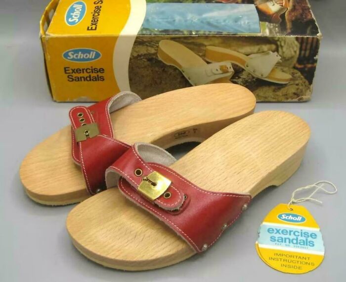 Vintage Scholl exercise sandals with wooden soles and red leather straps, a recognizable item that makes people feel very old.