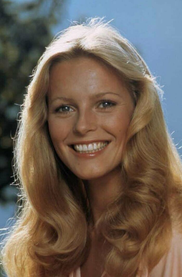 Smiling woman with long blonde hair and vintage 1970s hairstyle, a nostalgic image for people who recognize and feel old.