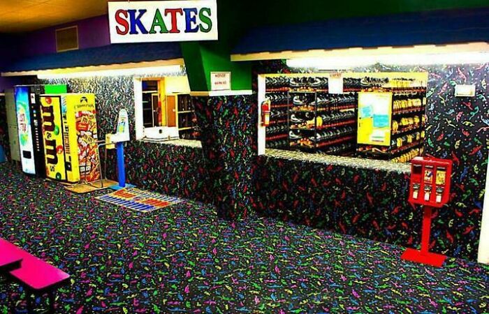 Retro roller rink interior with vibrant carpet and skate rental counter, a classic scene that makes people feel very old.