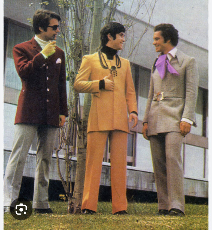 Three men in retro 1970s suits standing outdoors, a nostalgic image for people who recognize vintage fashion.