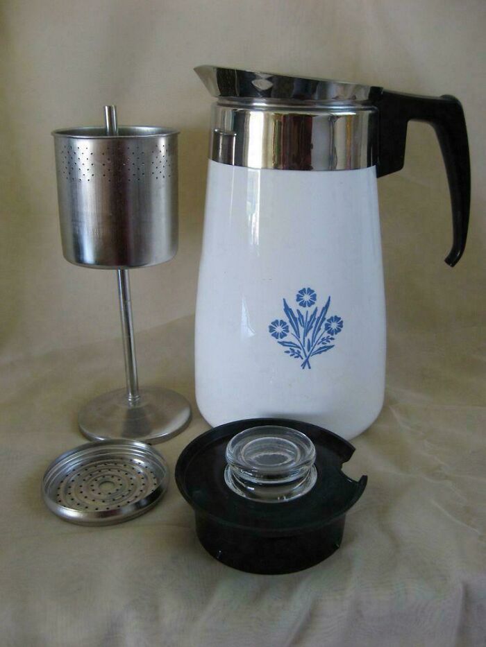 Vintage coffee percolator with metal filter and floral design, a classic item that makes people who recognize it feel very old