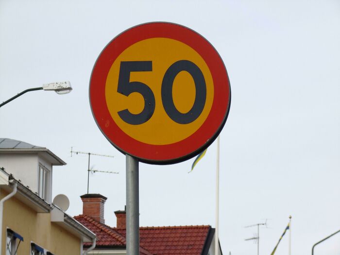 Speed limit sign showing 50 in a residential area, illustrating imperfect things that annoy people with OCD.