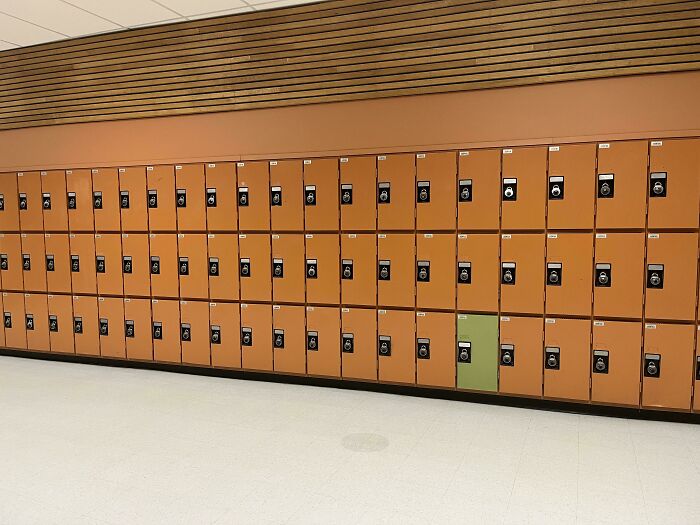 Row of orange lockers with one green locker standing out, illustrating imperfect things that annoy people with OCD.