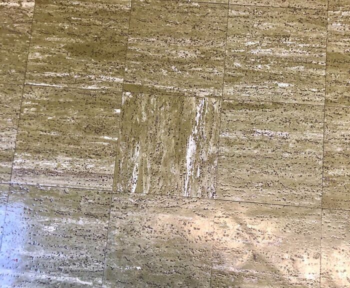 Floor tiles with one noticeably different pattern, illustrating imperfect things that annoy people with OCD.