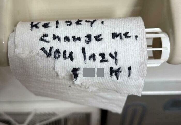 Toilet paper roll with a humorous handwritten note, showcasing hilarious dads nailing fatherhood with clever messages.