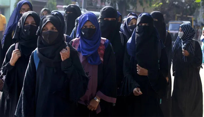 Group of women wearing face coverings and abayas walking outdoors, featured in online group sharing interesting facts and pics.