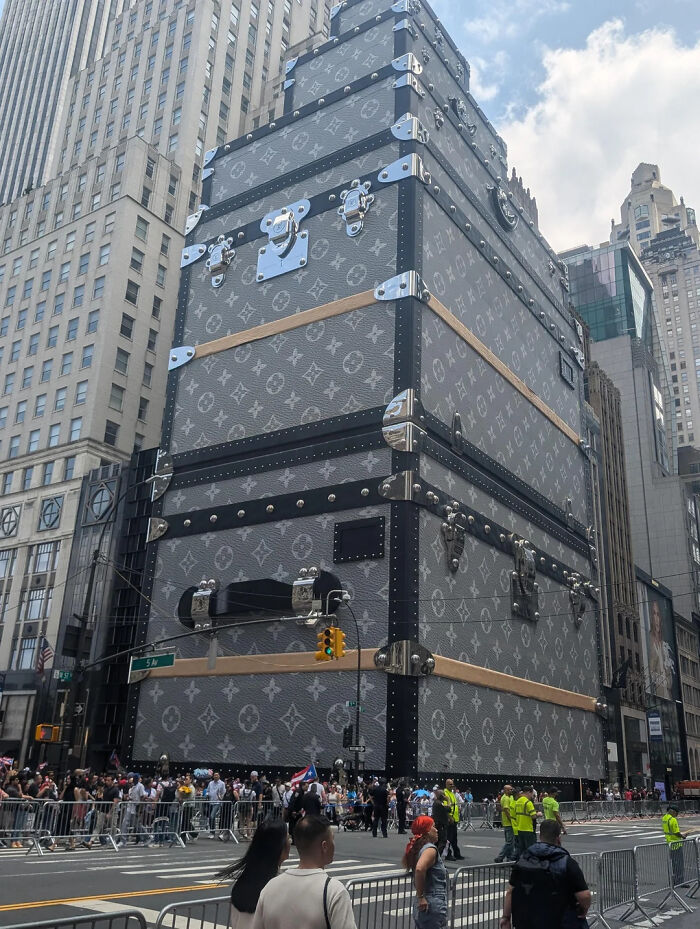 Giant Louis Vuitton trunk installation in city, attracting crowds and capturing attention in an interesting online group.