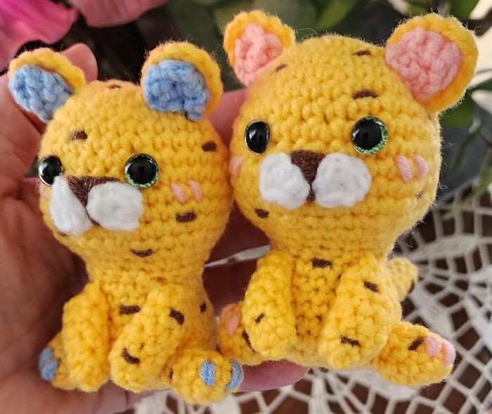 Two handmade crochet plush toys resembling tigers, showcasing a creative hobby to try after finishing internet browsing.