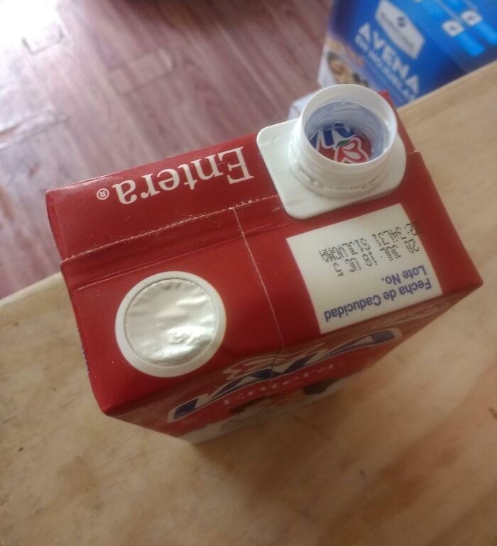 Partially opened milk carton with an imperfectly unscrewed cap, showing a common annoyance for people with OCD.