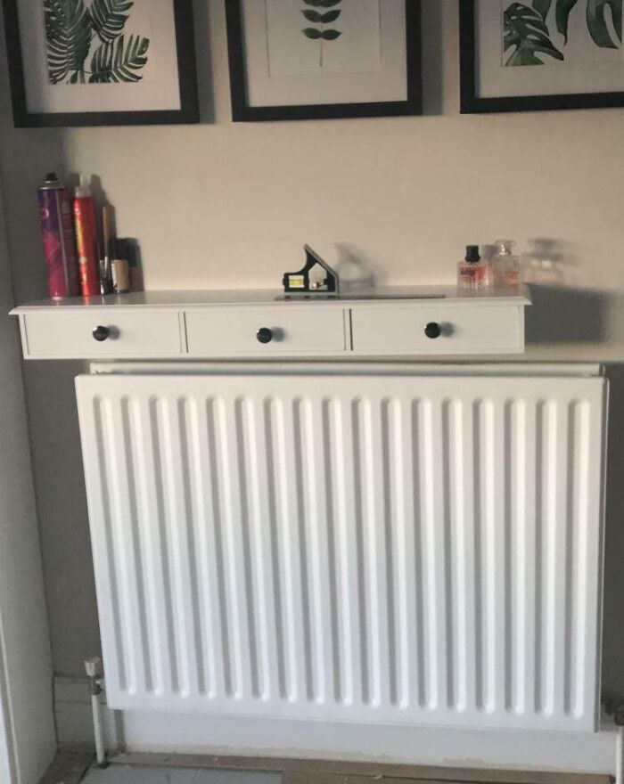 A white radiator with a shelf above it, items unevenly arranged, illustrating imperfect things that annoy people.