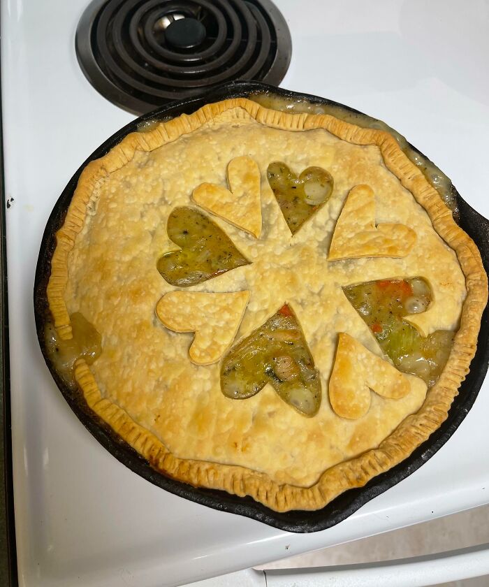 Homemade pot pie with uneven crust and filling spilling out, a common imperfect thing that might annoy people with OCD.