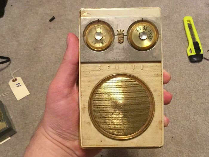 Vintage Zenith portable radio from the 1950s held in hand showing classic design and tuning dials.