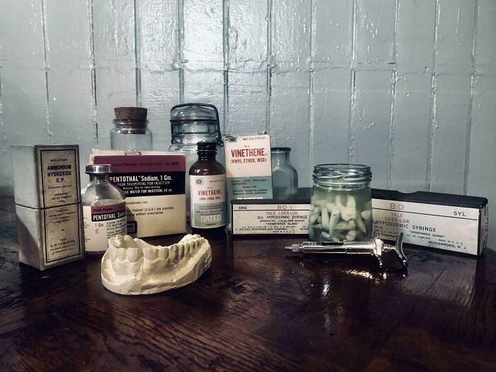 Vintage medical supplies and dental mold displayed on a wooden surface capturing life in the 1950s era.
