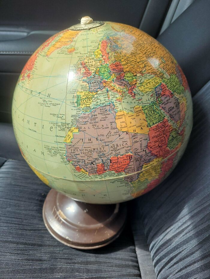 Vintage globe showcasing countries and borders, capturing the essence of life in the 1950s with historical maps and details.