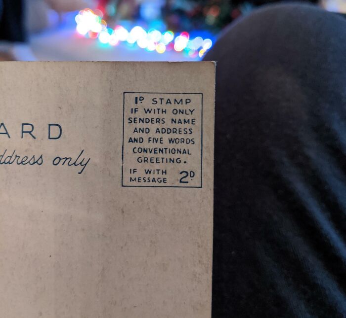 Close-up of a vintage postcard showing old stamp pricing, capturing the essence of life in the 1950s.