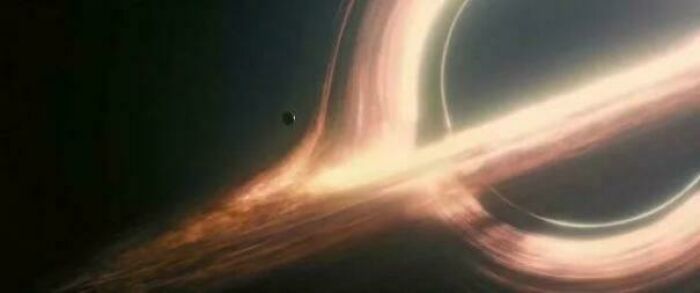 A visual of an extremely large and scary black hole with an eerie, glowing accretion disk in deep space.