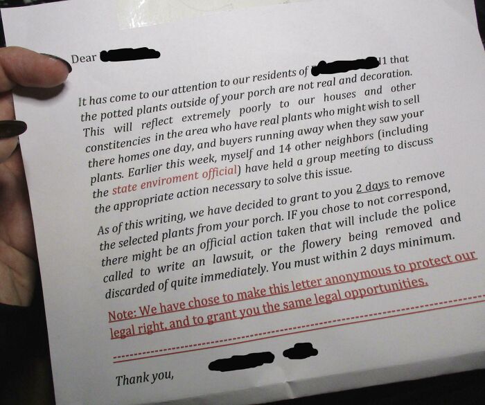 Handwritten unhinged neighbor’s note demanding removal of fake porch plants in a tense residential dispute.