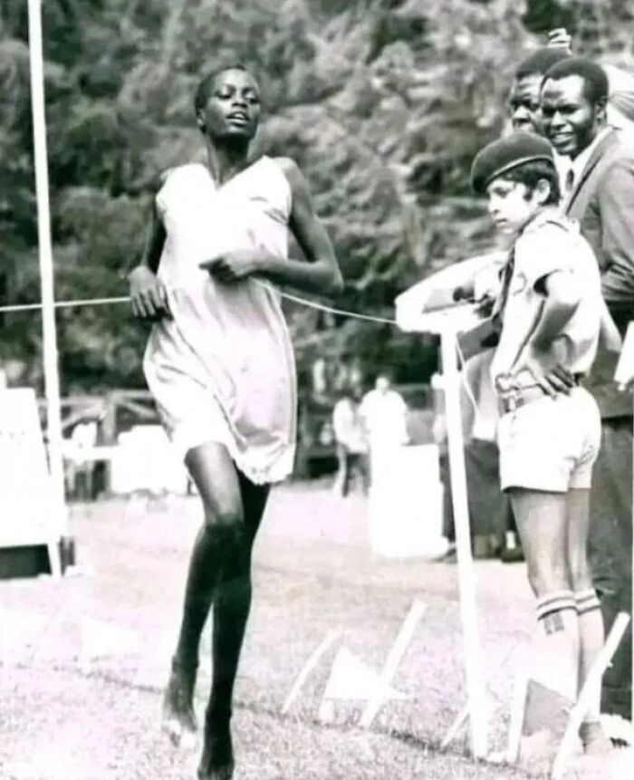 Black and white photo of a female runner finishing a race, shared by an online group about interesting facts and pics.