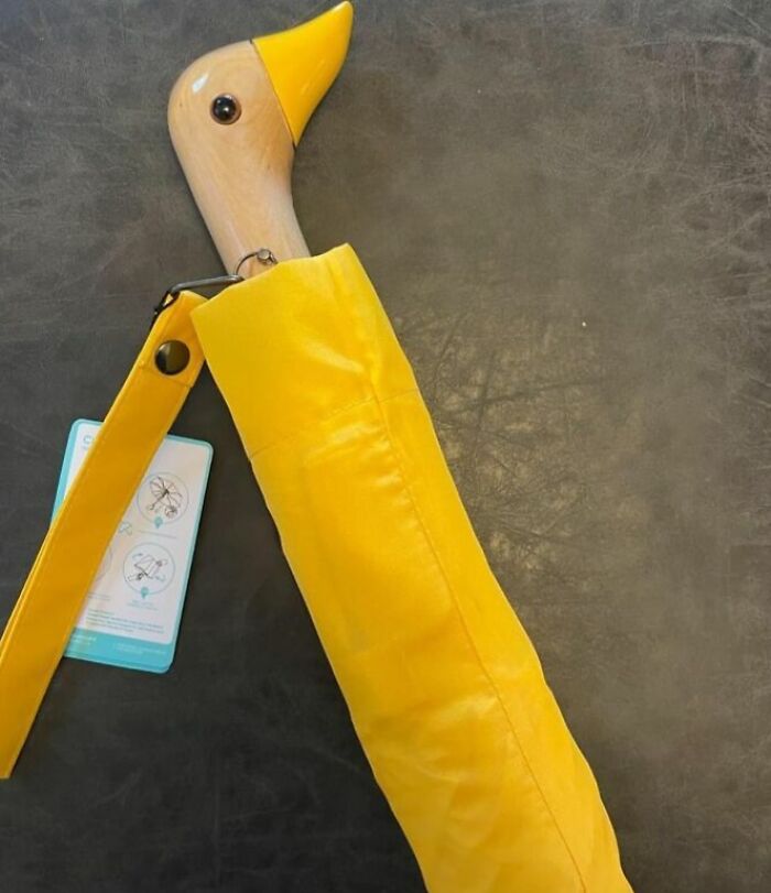 Wooden duck handle umbrella in bright yellow cover, a unique item for anyone who appreciates peak coolness.