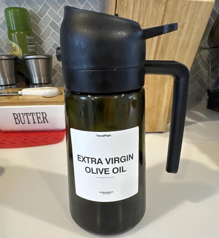 Olive oil dispenser bottle with handle on kitchen counter, one of the favorite problem solvers under $15 products.
