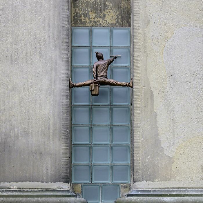 Street art interpretation showing a figure painting on glass blocks in public spaces by Frankey.