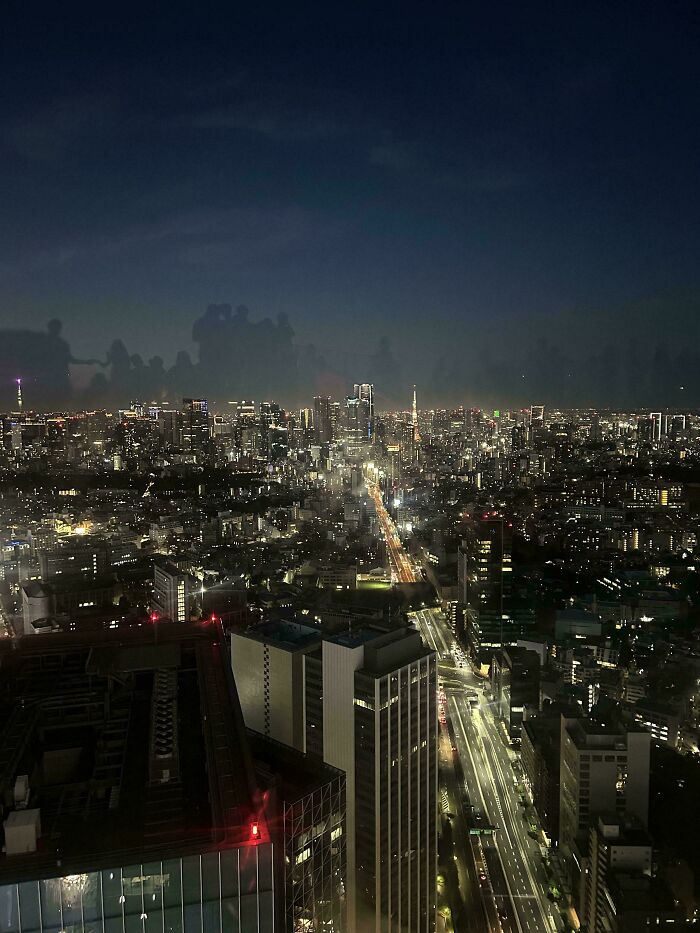 An aerial night view of an extremely large, sprawling city skyline with countless lights, creating a scary and eerie atmosphere.